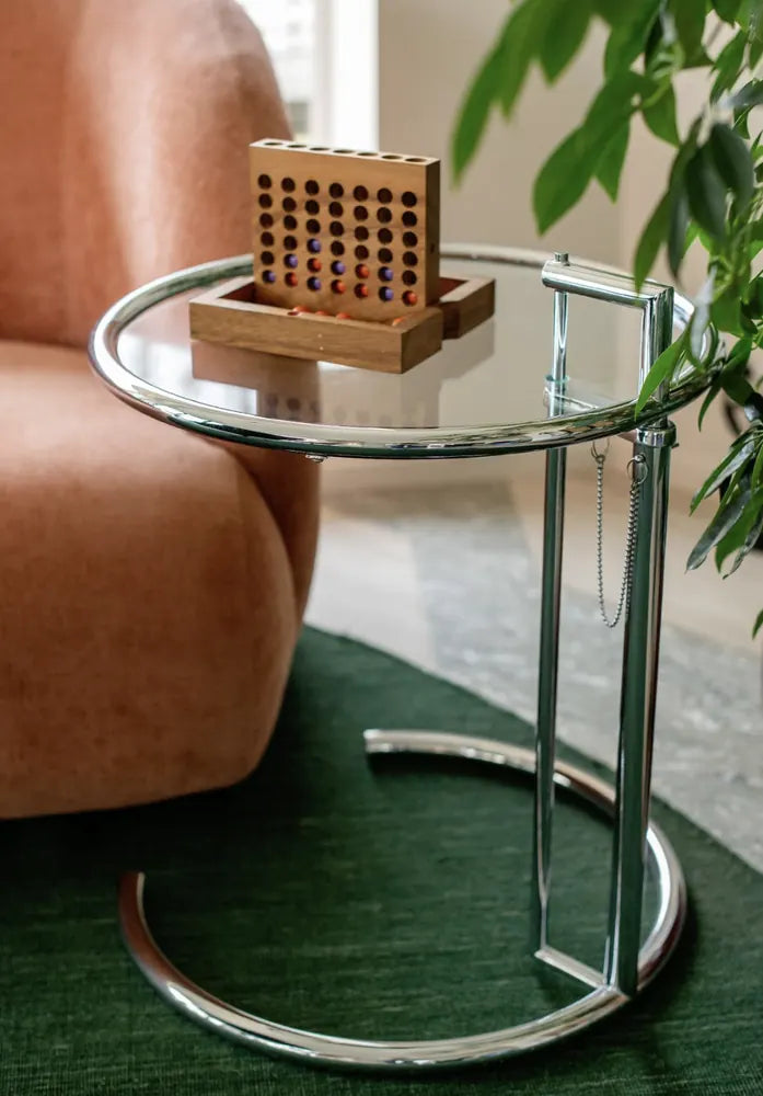 Height Adjustable Glass Side Table beside a lounge chair